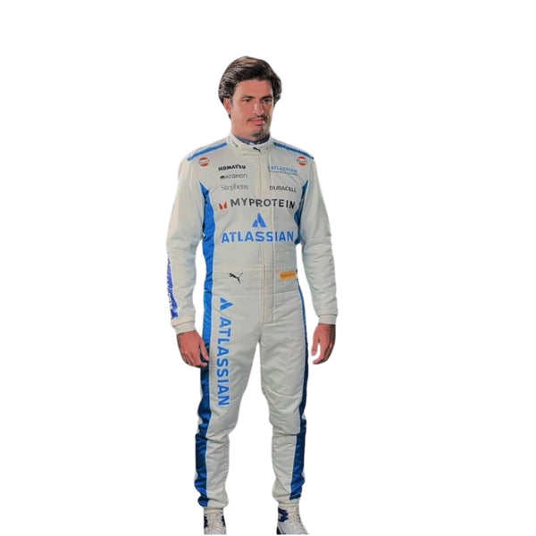 Front view of Carlos Sainz's 2025 F1 racing suit in white with blue side panels, featuring sponsor logos and a sleek design. Explicit Pro