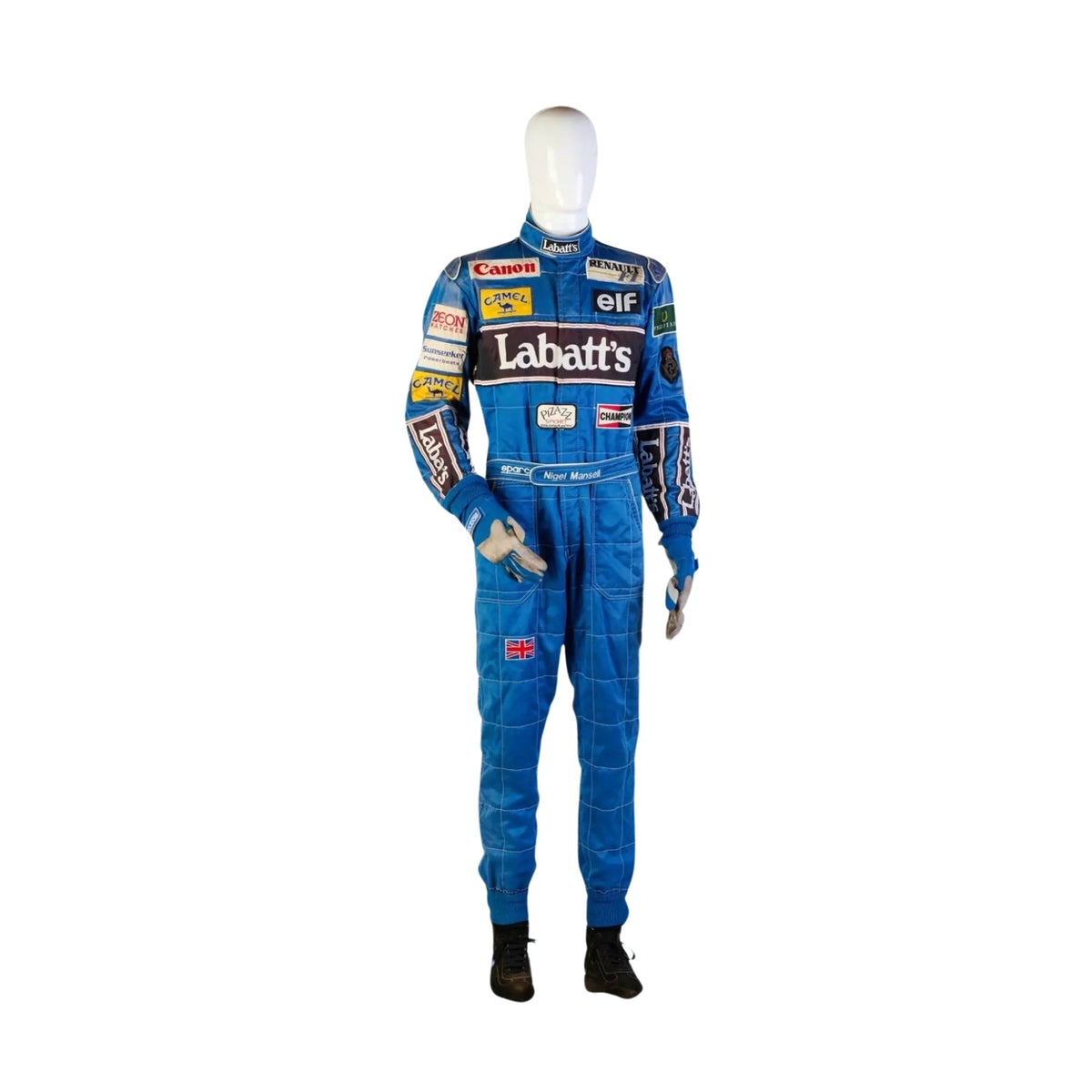 Front view of Nigel Mansell’s 1992 Formula 1 racing suit, featuring a vibrant blue base with red and white detailing, iconic sponsor logos, and a bold chest panel. Main image